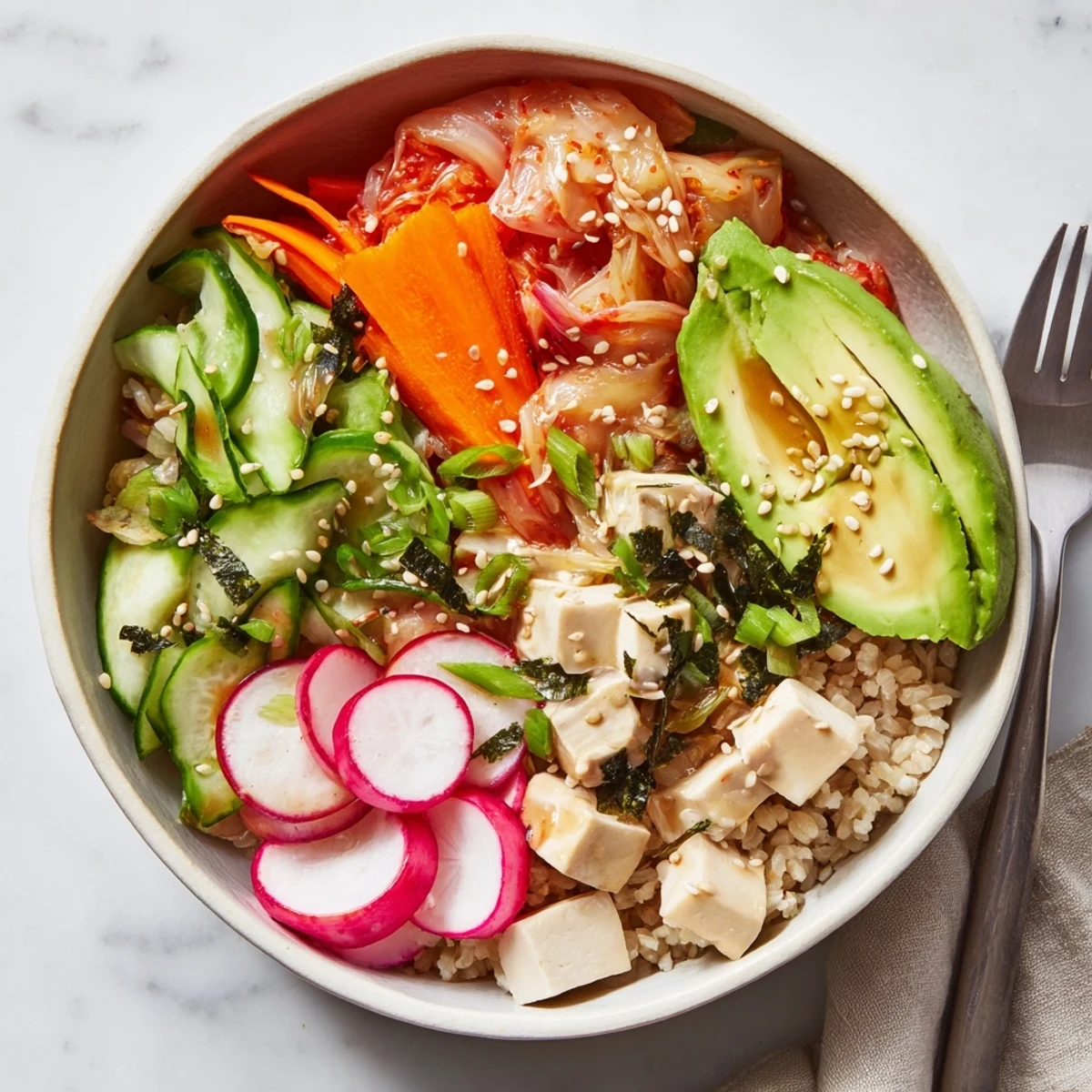 A colorful fermented vegetable bowl with kimchi, fresh greens, and grains.  
