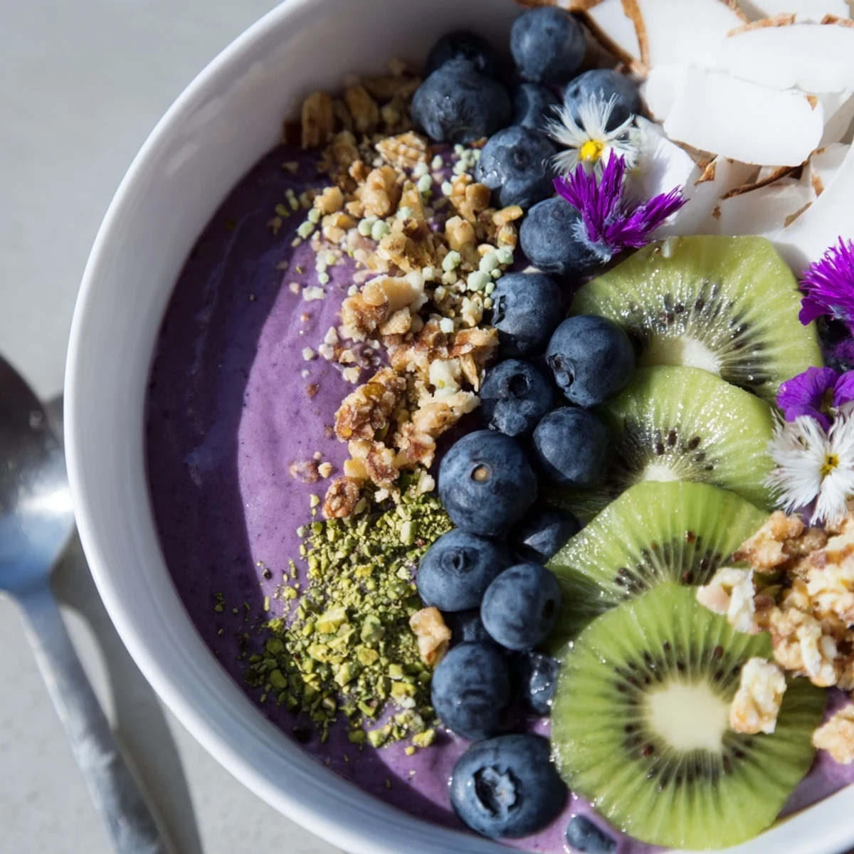 Colorful smoothie bowls topped with pistachios and berries, perfect for breakfast delights.  