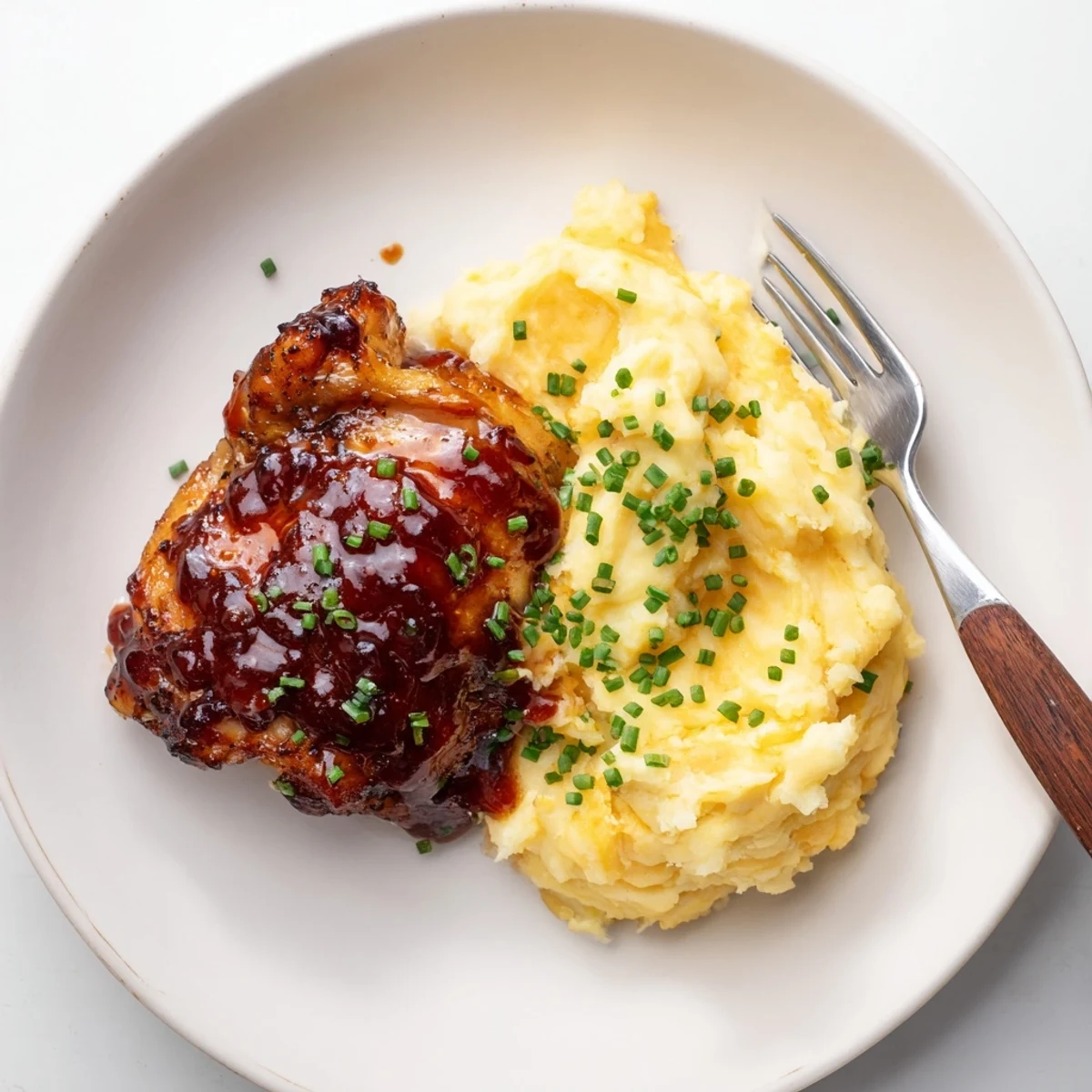 Succulent honey BBQ chicken thighs served with creamy garlic mashed potatoes.  