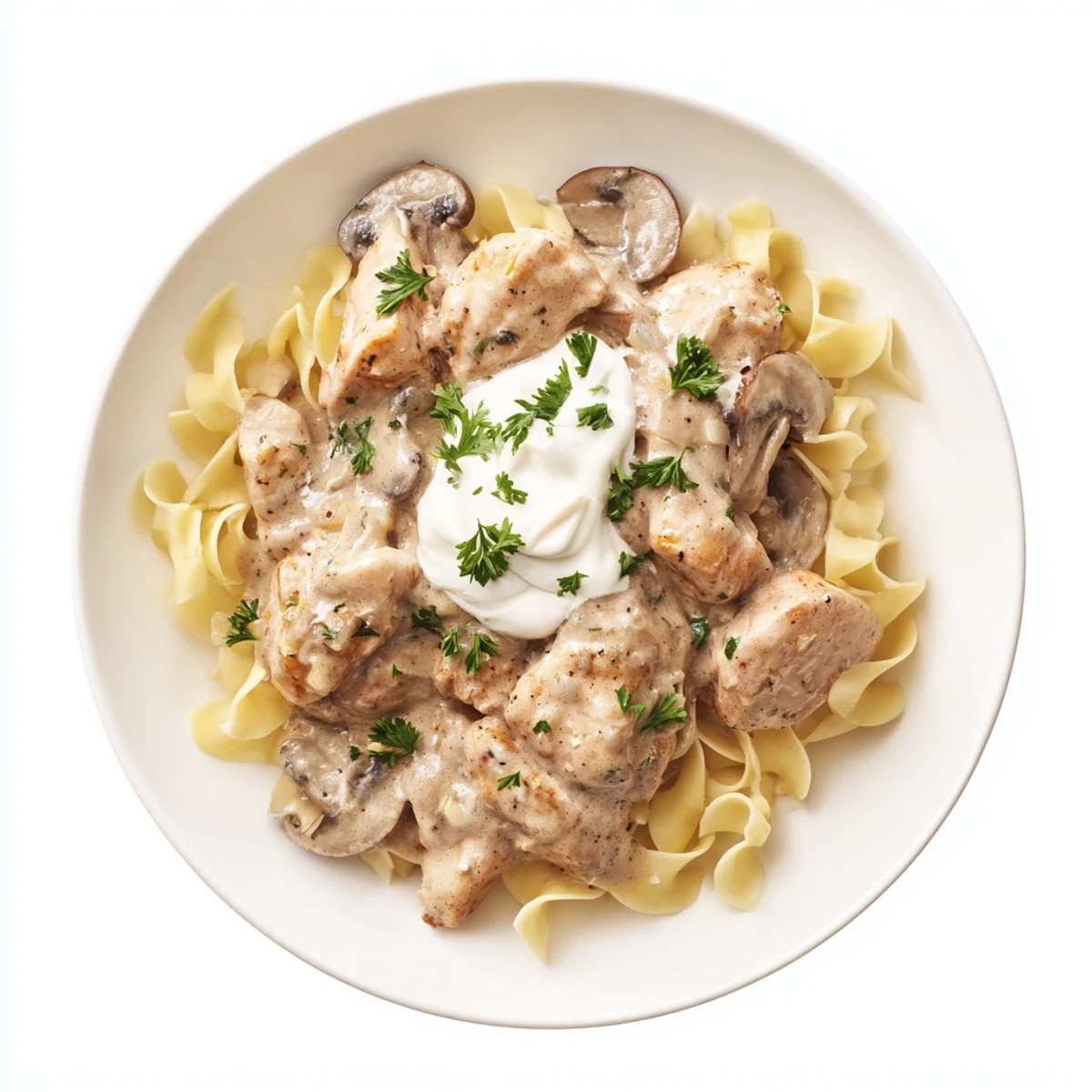Tender Creamy Chicken Stroganoff over egg noodles, a hearty meal with rich, mushroom-infused sauce.