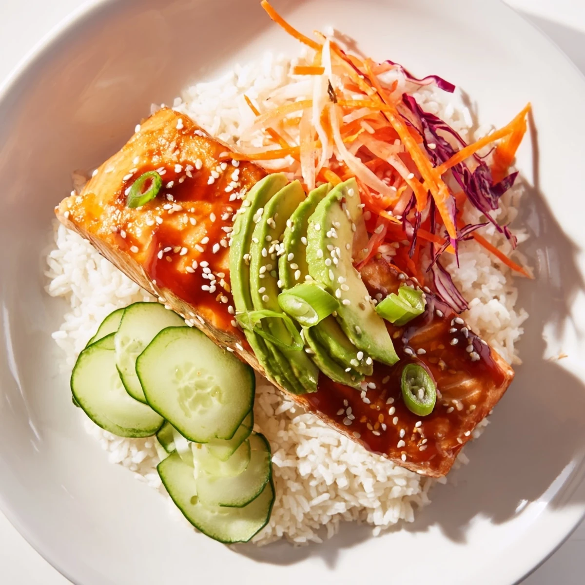 Golden-brown sweet chili salmon rests atop fluffy rice, ready for this flavorful rice bowl.