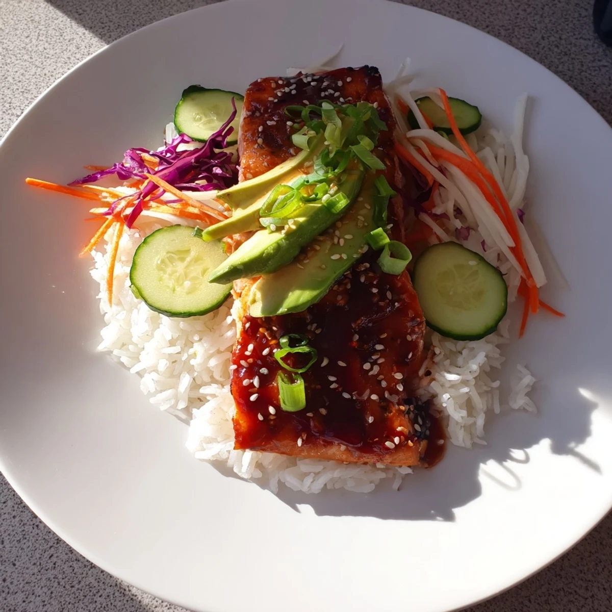 Steaming sweet chili salmon bowl with colorful veggies and a swirl of the delicious sauce.