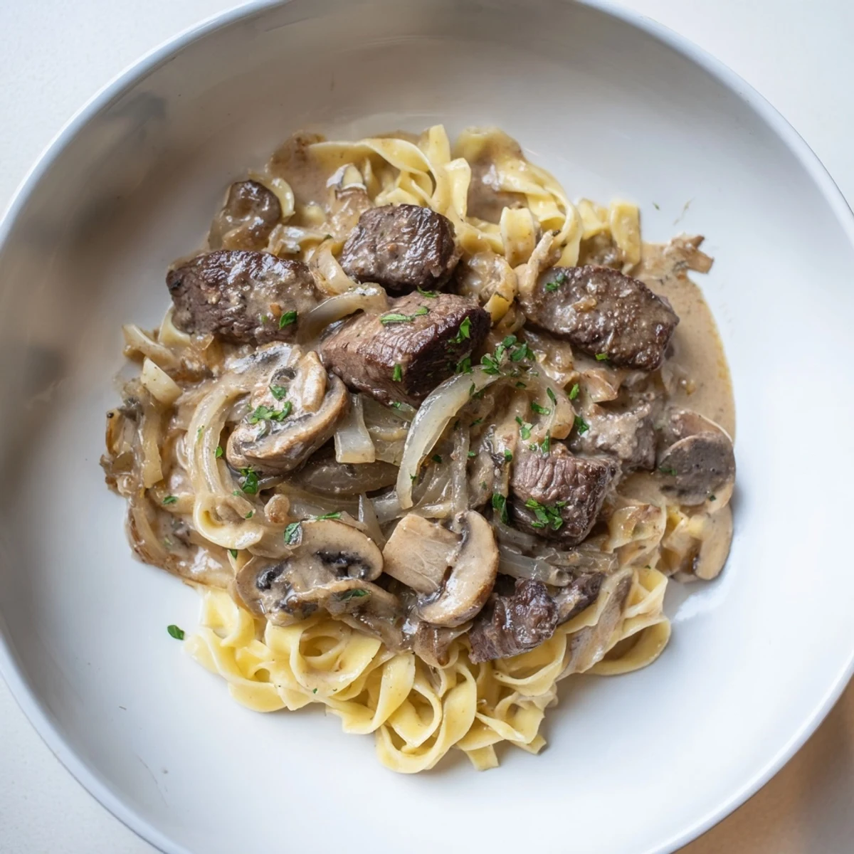 Classic Creamy Mushroom Beef Stroganoff: Savory dish featuring beef strips and noodles, enriched with a rich creamy sauce.