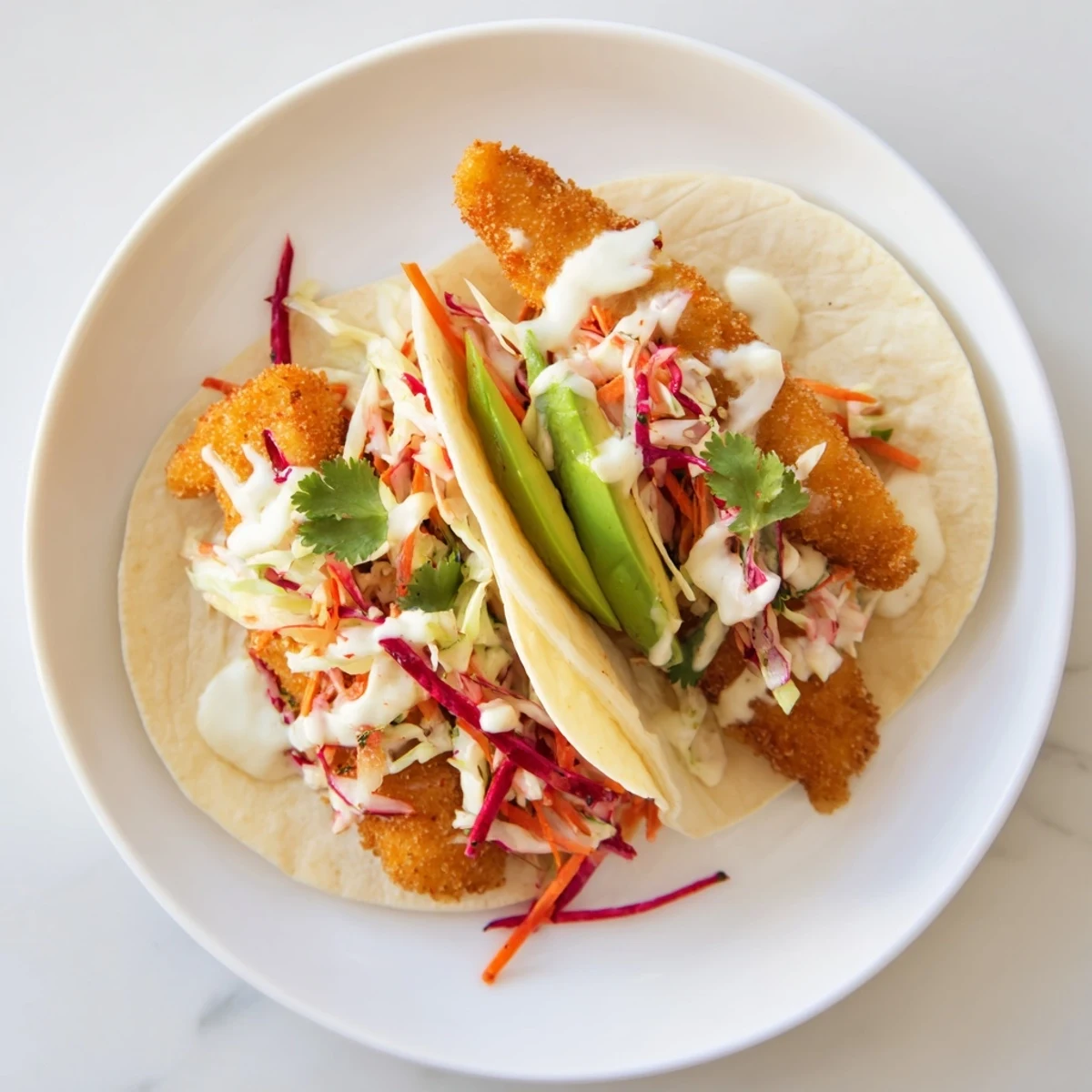 Golden, crispy fish tacos overflowing with fresh slaw, ready for a flavorful bite.