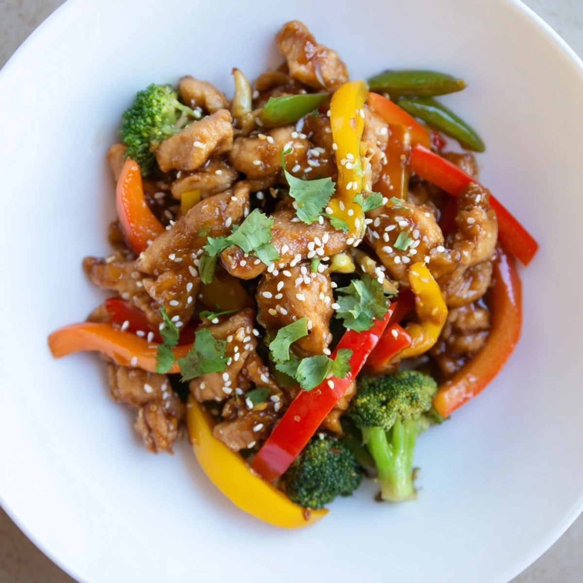 Steaming Chicken Stir-Fry with Vegetables and Rice, fragrant with ginger, ready to serve over fluffy rice.