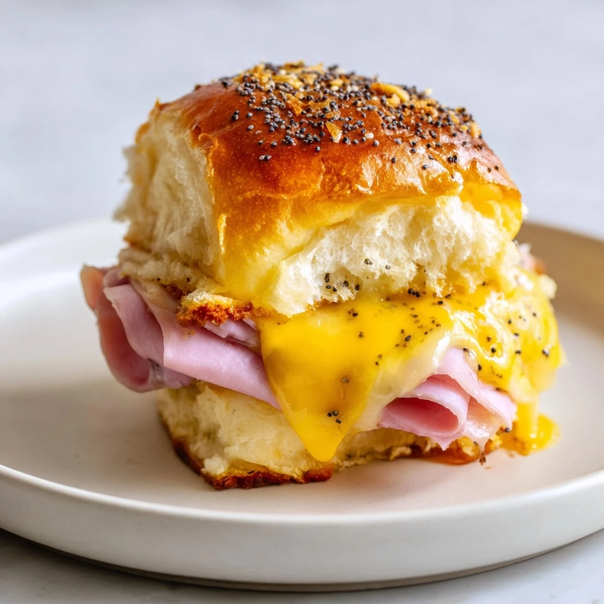 Warm, cheesy, and irresistible Baked Ham and Cheese Party Sliders fresh from the oven, ready to serve.