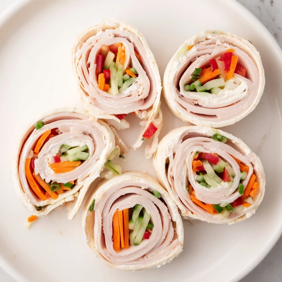 Delicious Smoked Turkey Pinwheels Tree, perfectly plated, with fresh vegetables visible, ideal for your party.
