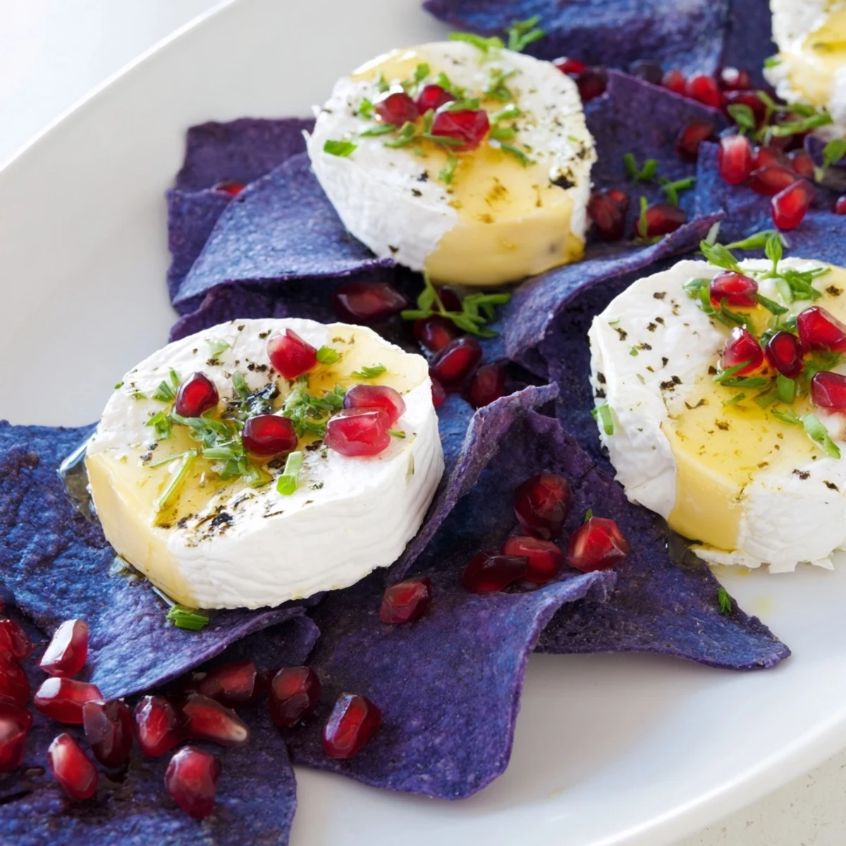 A beautiful platter of The Stepping Stones: cheese rounds on blue chips with fresh garnishes.