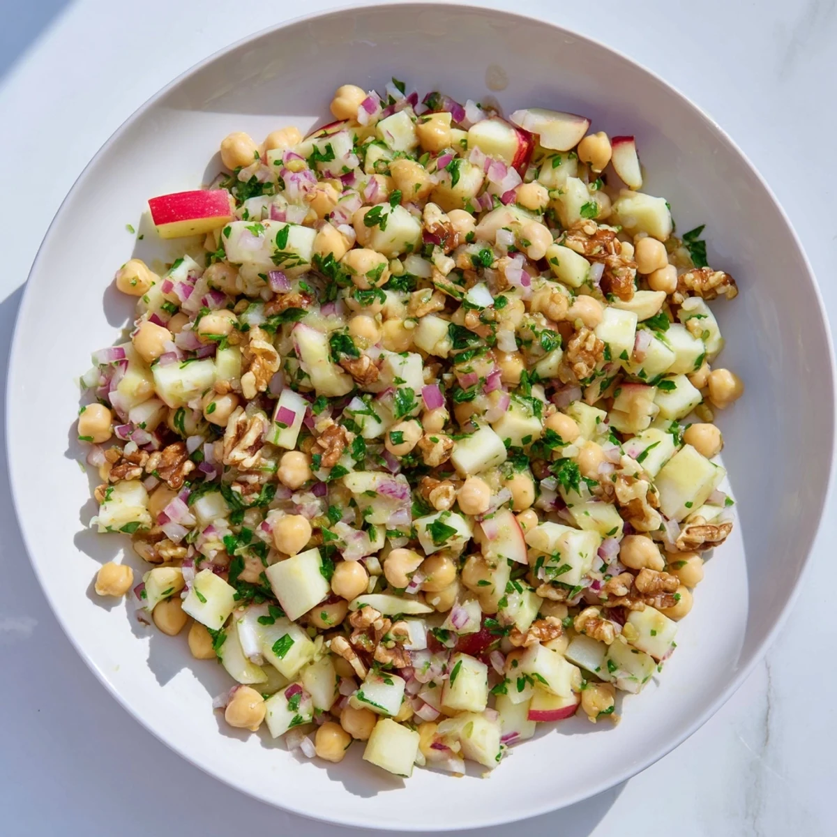 Close-up of Fall Harvest Apple and Chickpea Salad, a vegetarian delight with diced apples and creamy chickpeas.