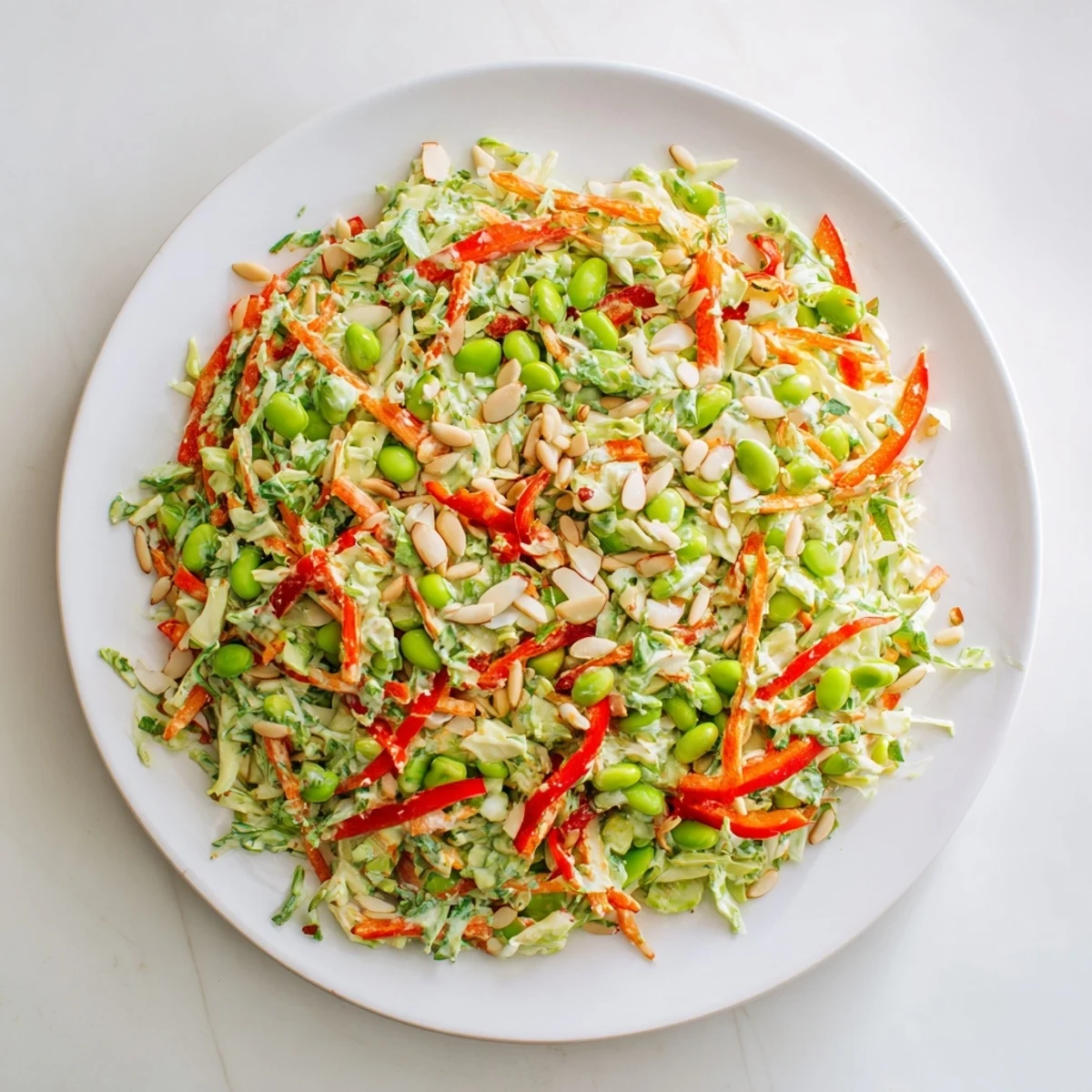 Close-up of a refreshing Crunchy Cabbage and Edamame Salad, topped with crunchy sunflower seeds and almonds.