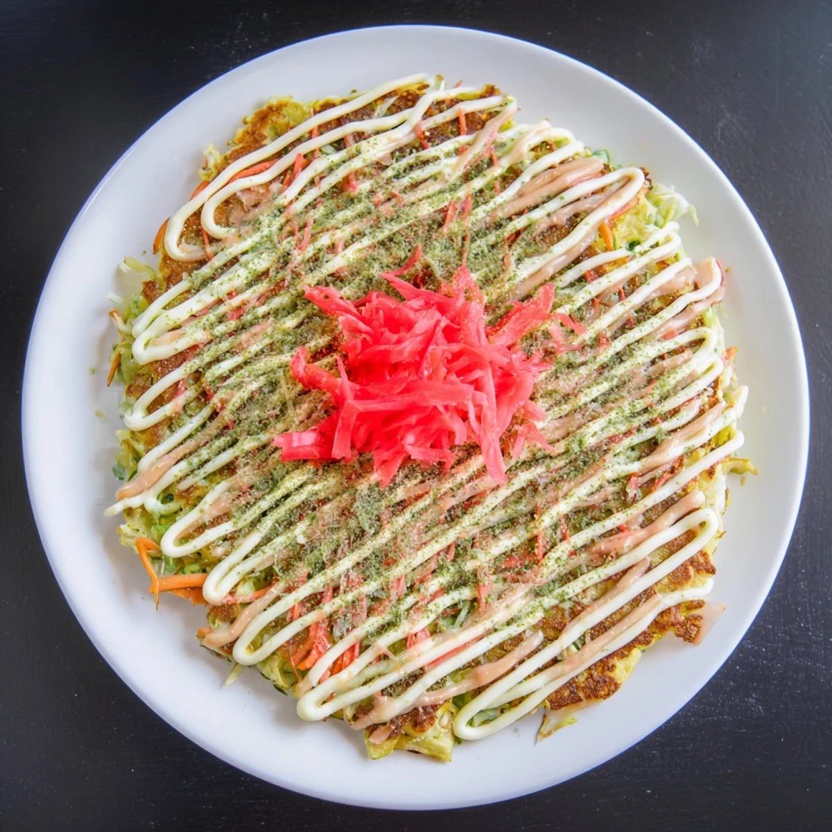 Enjoy a delicious plate of golden-brown Japanese Okonomiyaki, savory pancake perfection everyone will love.