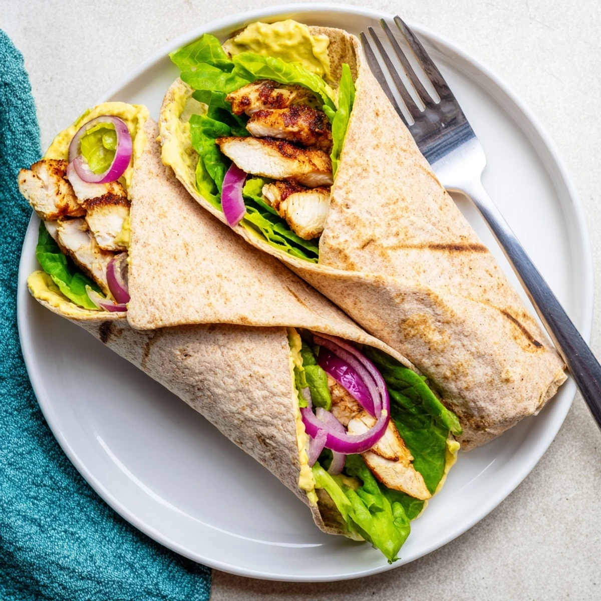 Golden-brown chicken slices, crisp romaine lettuce, and vibrant tomato wedges drizzled with sweet honey-mustard dressing inside a fresh flour tortilla.