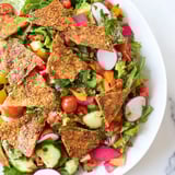 A close-up view of Fattoush Crunch Salad; crunchy pita chips atop fresh, flavorful ingredients.
