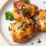 Savory honey garlic glazed chicken, a flavorful main dish with glistening, sticky, sauce coating it.
