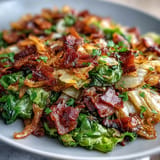 Tender sautéed cabbage, smoky bacon, and onions, a Southern comfort side.