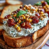 Sweet corn, juicy tomatoes top creamy butter board, perfect for parties.