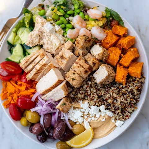 A colorful build-your-own board, featuring grilled chicken, fresh veggies, and sauces.  