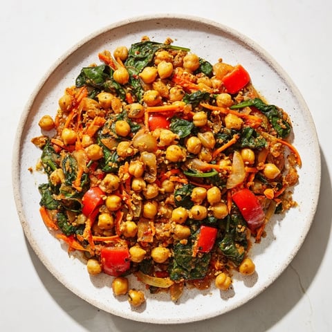 Steaming Vegetarian Chickpea & Spinach Skillet, bursting with Mediterranean flavors fresh from the pan.