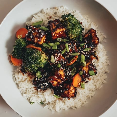 Golden, crispy sesame tofu and broccoli, richly coated and ready to serve over fluffy rice.