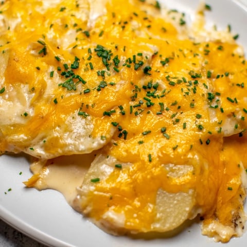 Golden-brown, bubbly cheesy scalloped potatoes, a comforting side dish perfect for any holiday meal.