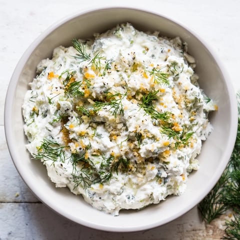 Creamy, savory Fried Pickle Dip served with crunchy potato chips, a perfect appetizer.