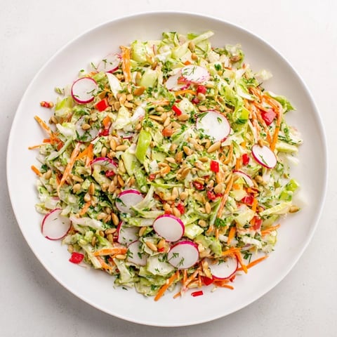 A vibrant Green Goddess Confetti Chop Slaw with colorful raw veggies coated in creamy dressing.