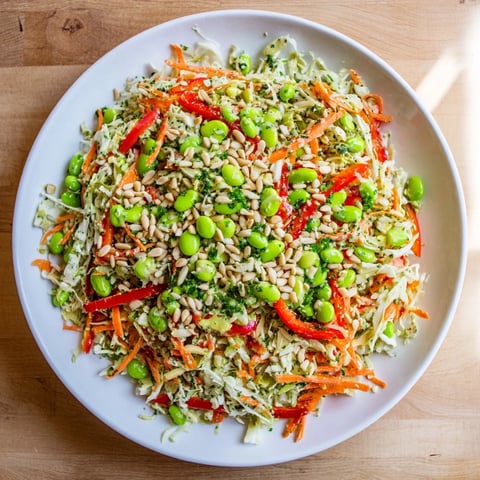 A colorful Crunchy Cabbage and Edamame Salad, featuring vibrant veggies in a creamy dressing.