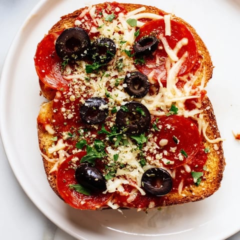 Golden, bubbly Air Fryer Pizza Toast, topped with melted cheese and savory pepperoni, ready to eat.