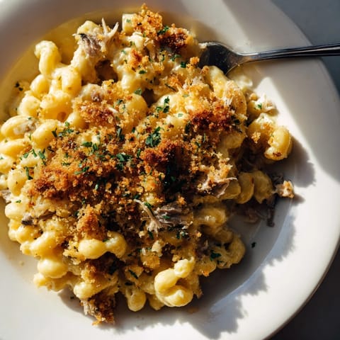 Creamy Mac and Cheese with Sardines: A comforting casserole, topped with fresh parsley.