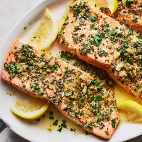 Succulent Festive Herb-Roasted Salmon fillets, infused with aromatic herbs and citrus flavors.  