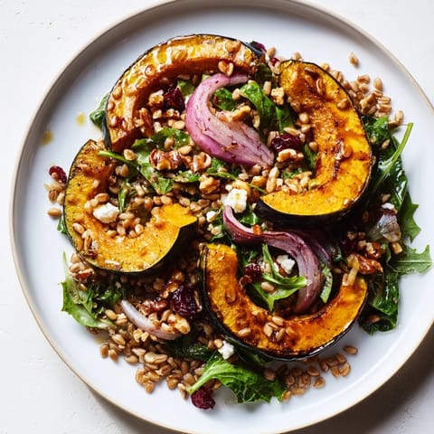 Hearty Farro & Mustard Green Salad with tender squash, a bright vinaigrette, and toasted pecans for crunch.