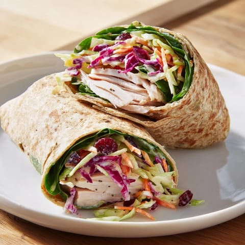 Sliced turkey and refreshing cranberry apple slaw nestled in a whole wheat wrap, appealing and delicious.