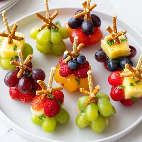 Fresh, vibrant Ornament Fruit Medley, featuring strawberries and grapes, perfect for a healthy holiday dessert.