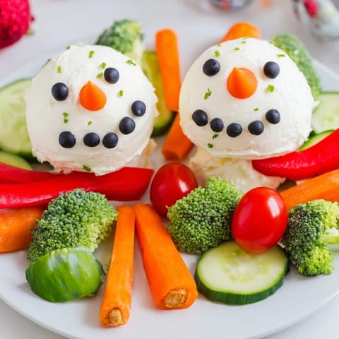 A festive Snowman Veggie Dip Platter, perfect for a cheerful holiday appetizer with colorful crudités.