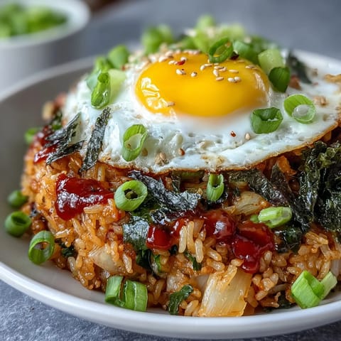 Spicy fermented cabbage kimchi fried rice bowl with a perfectly fried egg on top.