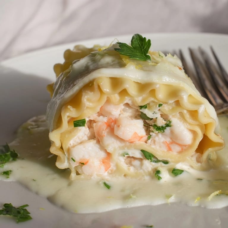 Making savory Shrimp Alfredo Lasagna Rolls &ndash; al dente pasta, cheesy filling, divine aroma.