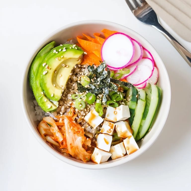 Hearty fermented vegetable bowl featuring tangy kimchi, quinoa, and vibrant toppings.