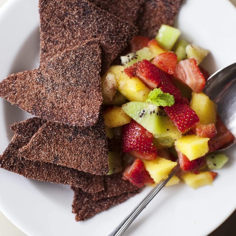 Sweet chocolate tortilla chips accompanied by colorful fruit salsa for dipping delight.