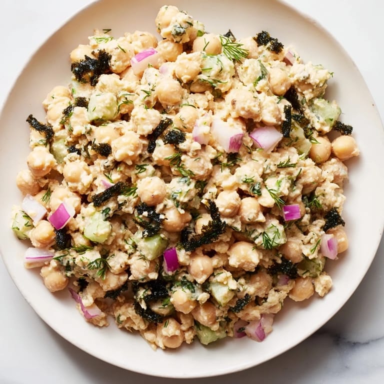 Close-up of a bowl filled with vibrant chickpea tuna salad, ready to eat for a quick, healthy meal.