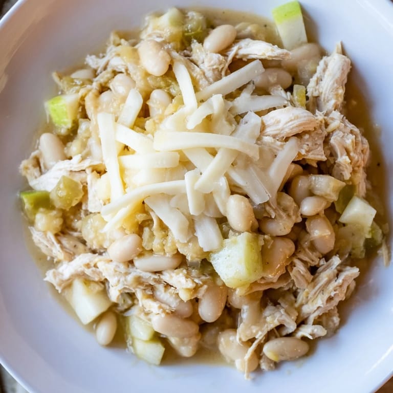 A close-up of hearty 35-Minute White Cheddar Apple Chicken Chili, perfect for a cozy dinner.