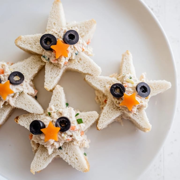 Freshly assembled mini starfish sandwiches, showing a festive tuna salad creation for a delightful appetizer platter.