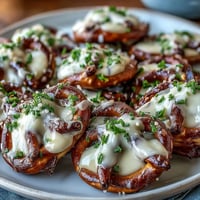 Festive St. Patrick's Day Shamrock Pretzel Bites with white chocolate and green sprinkles, perfect for sweet and salty snacking.