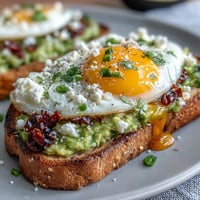 Creamy avocado spread on toasted sourdough, topped with a poached egg and drizzled with fragrant chili crisp for a spicy, satisfying breakfast.